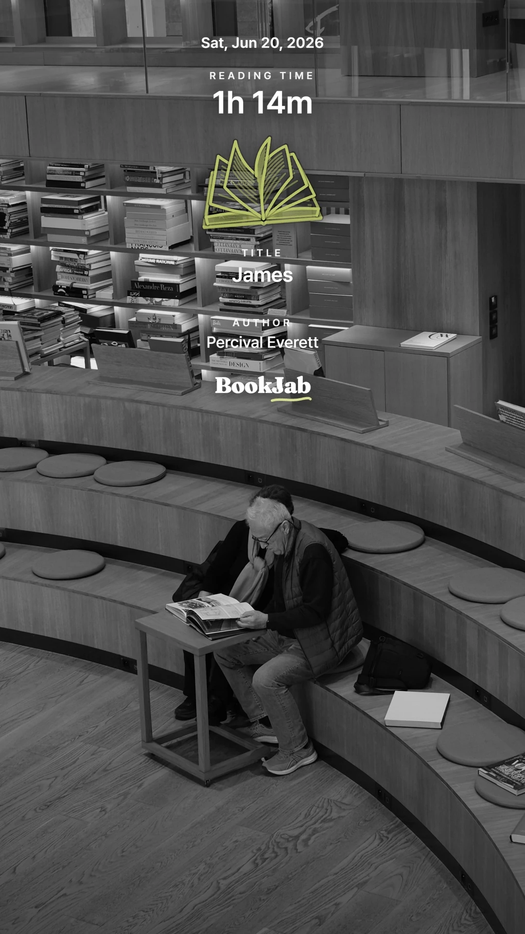 James · 1h 14m — a man reading on library tiered seating, black and white